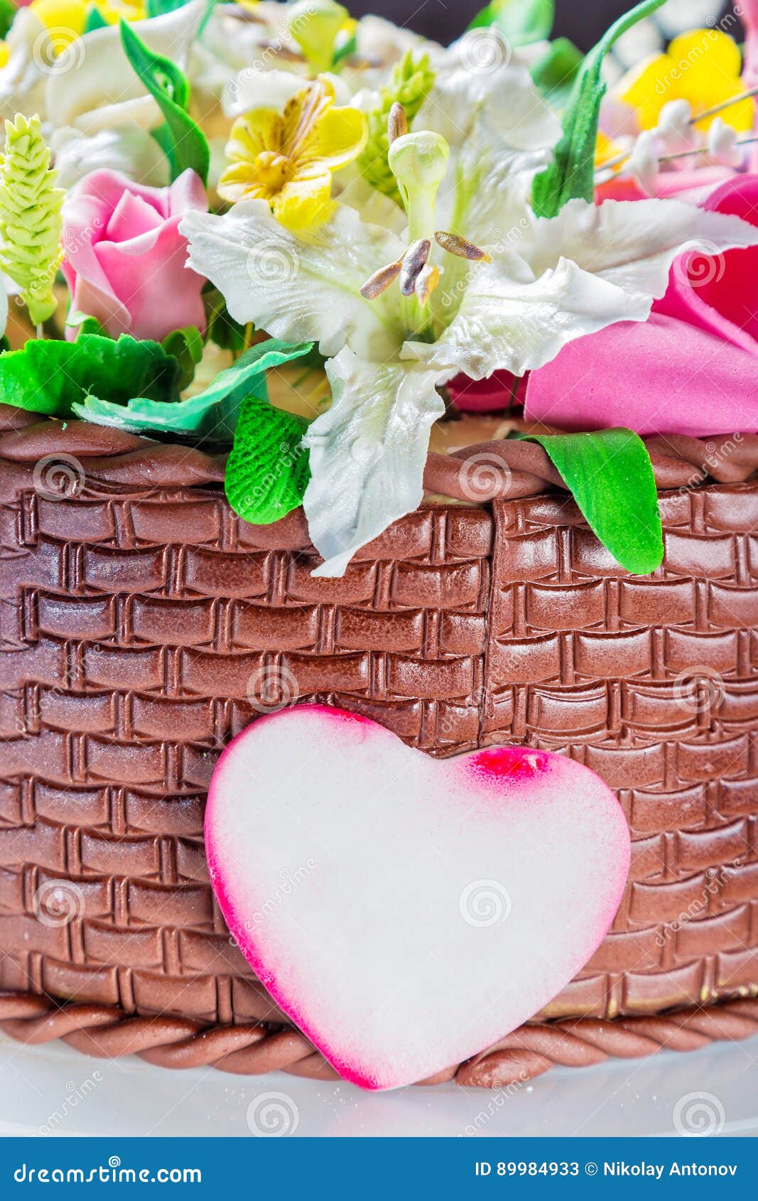 Delicious Cake Basket with Various Flowers and Decorative Heart Stock