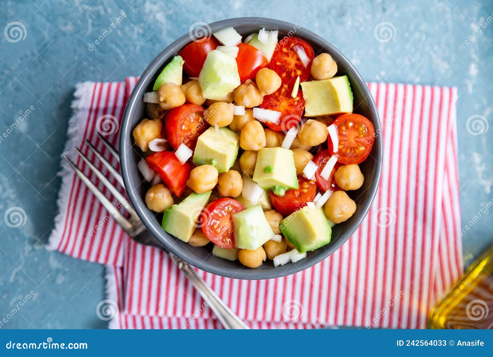 delicious chickpea salad with cherry tomato, avocado and cucumber