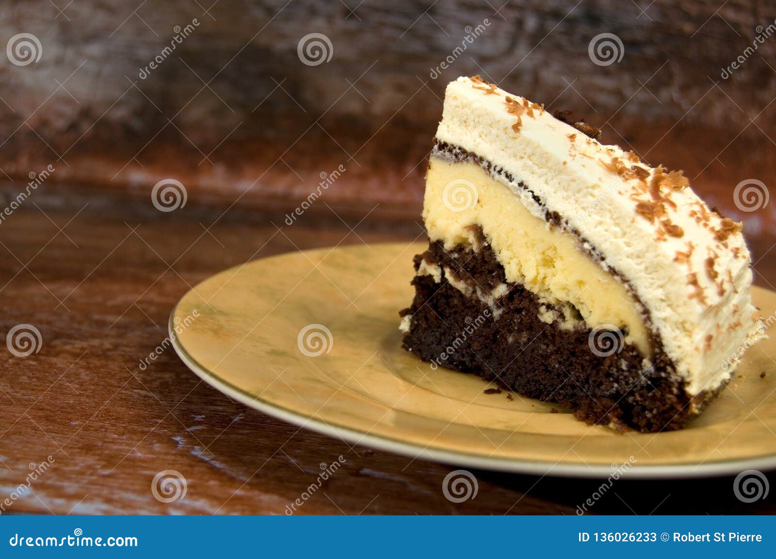 delicious chocolate and cream cake with icing on rustic looking wood vertical