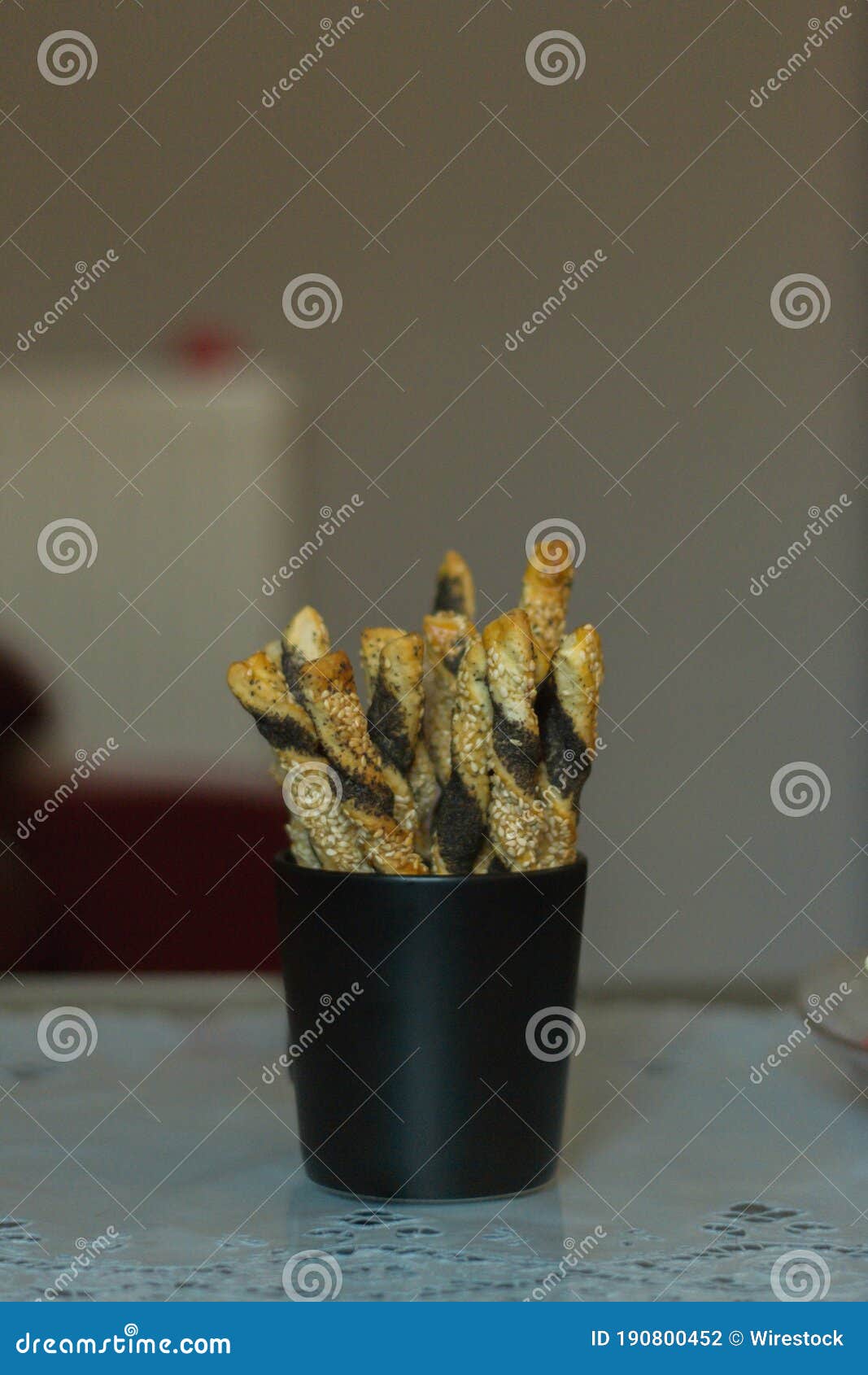 Delicious Crunchy Breadsticks Coated with Sesame Seeds in a Black