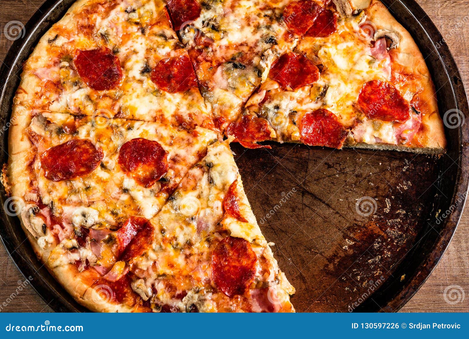 Delicious Cut Pizza In A Large Round Plate Stock Photo Image Of Miss Wooden