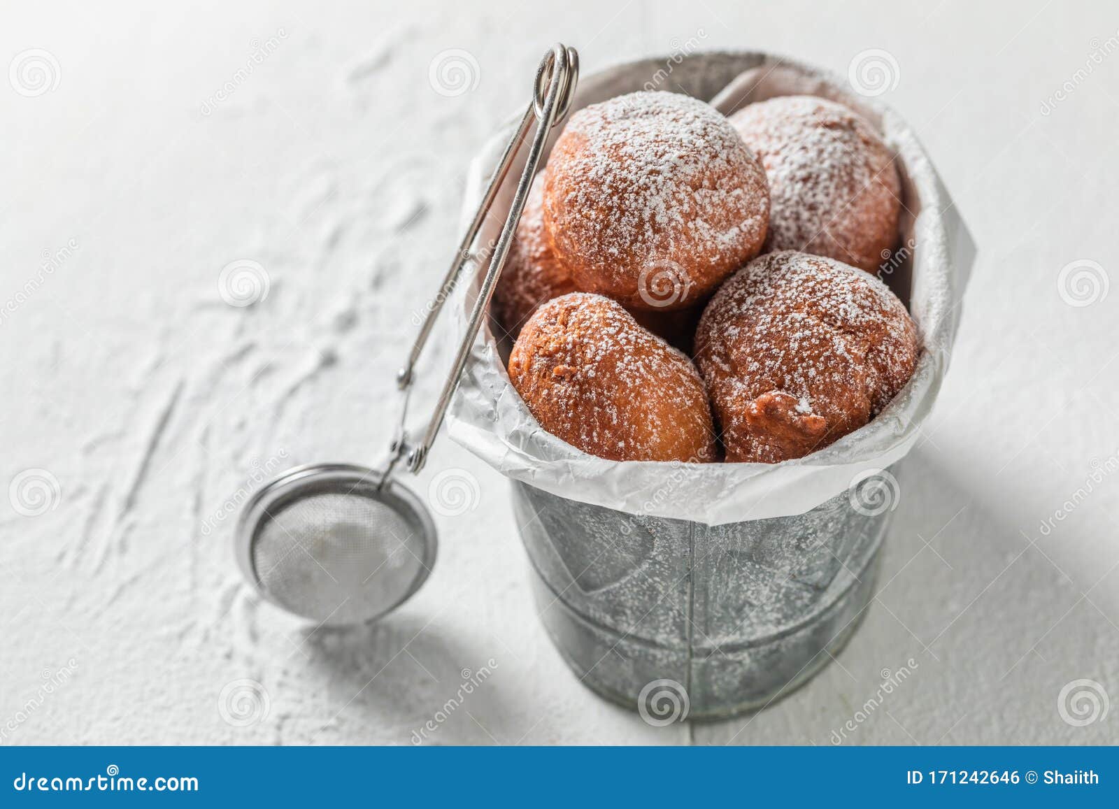 Delicious Donuts Balls with Powdered Sugar on White Table Stock Photo