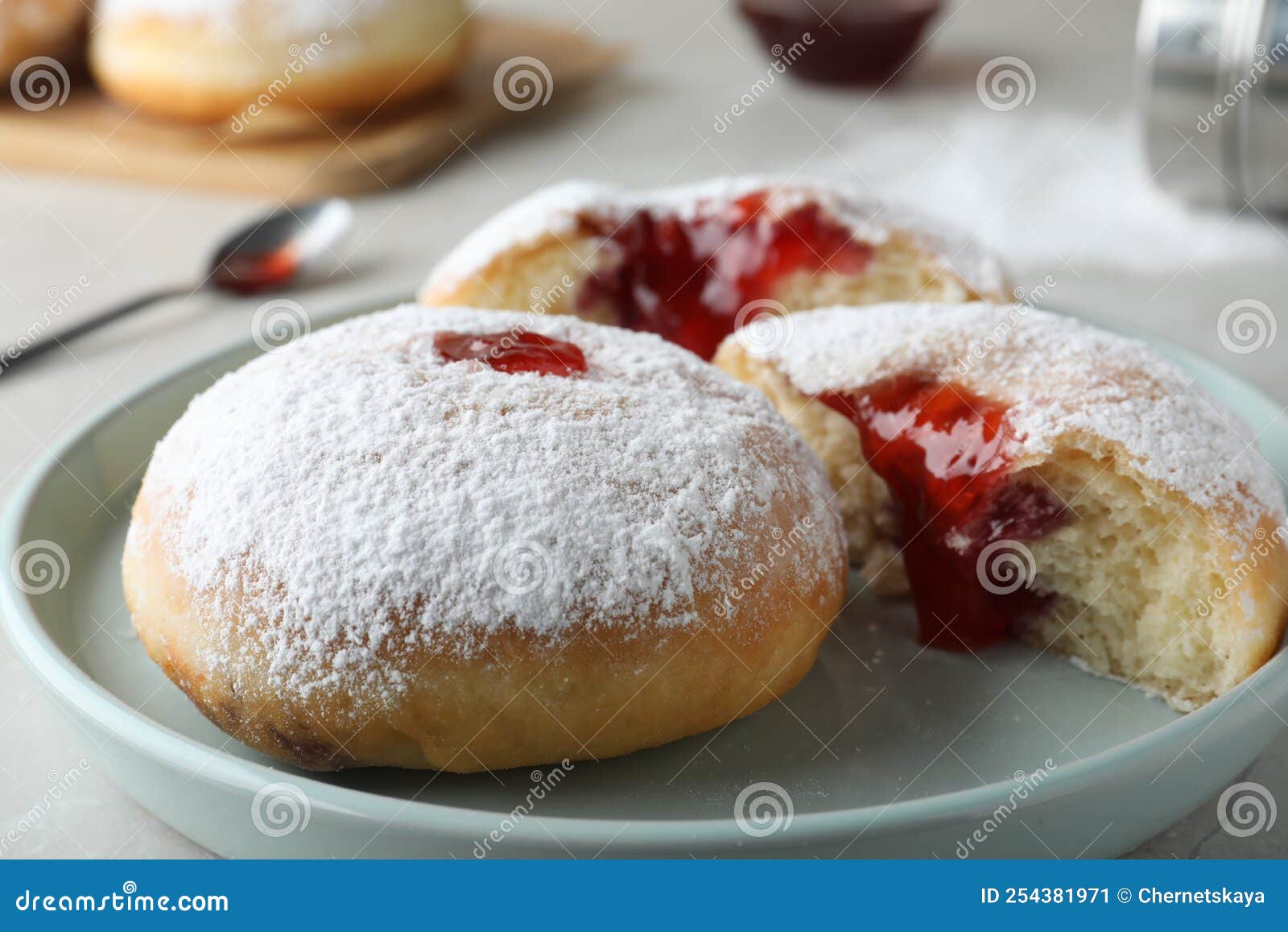 Delicious Donuts with Jelly and Powdered Sugar on Plate Stock Image