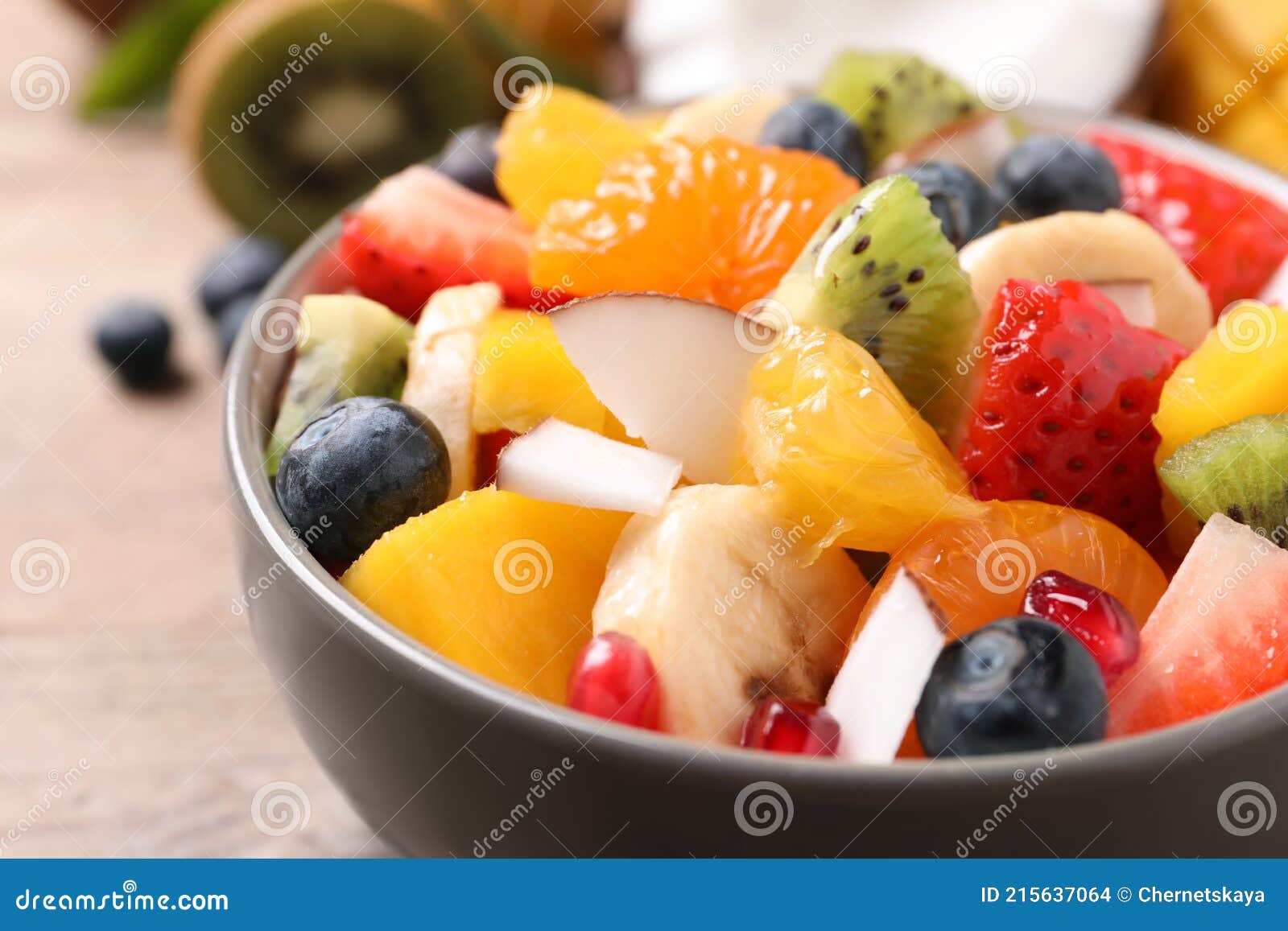 Delicious Fresh Fruit Salad in Bowl on Table, Closeup Stock Photo