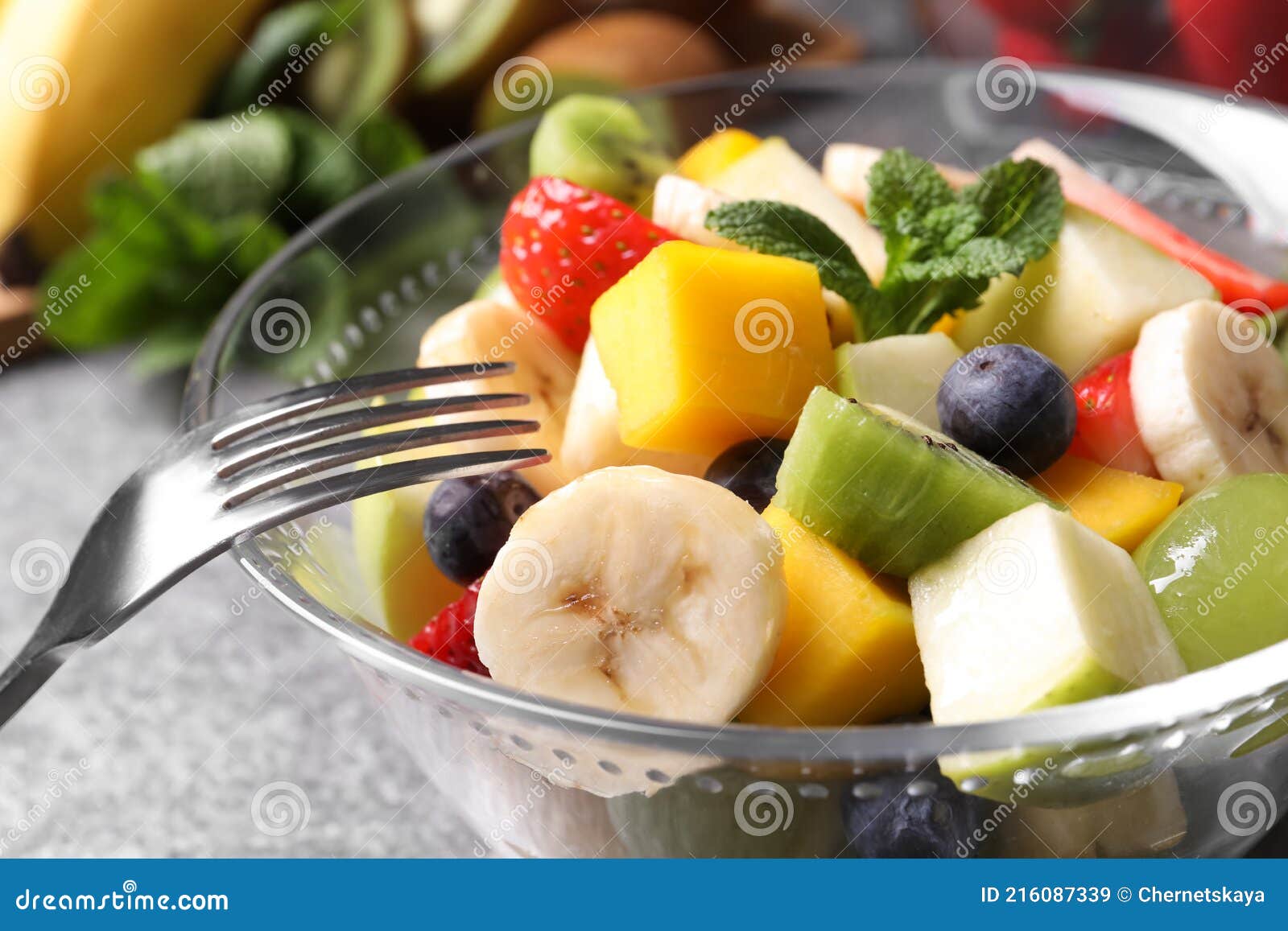Delicious Fresh Fruit Salad in Bowl on Table, Closeup Stock Image