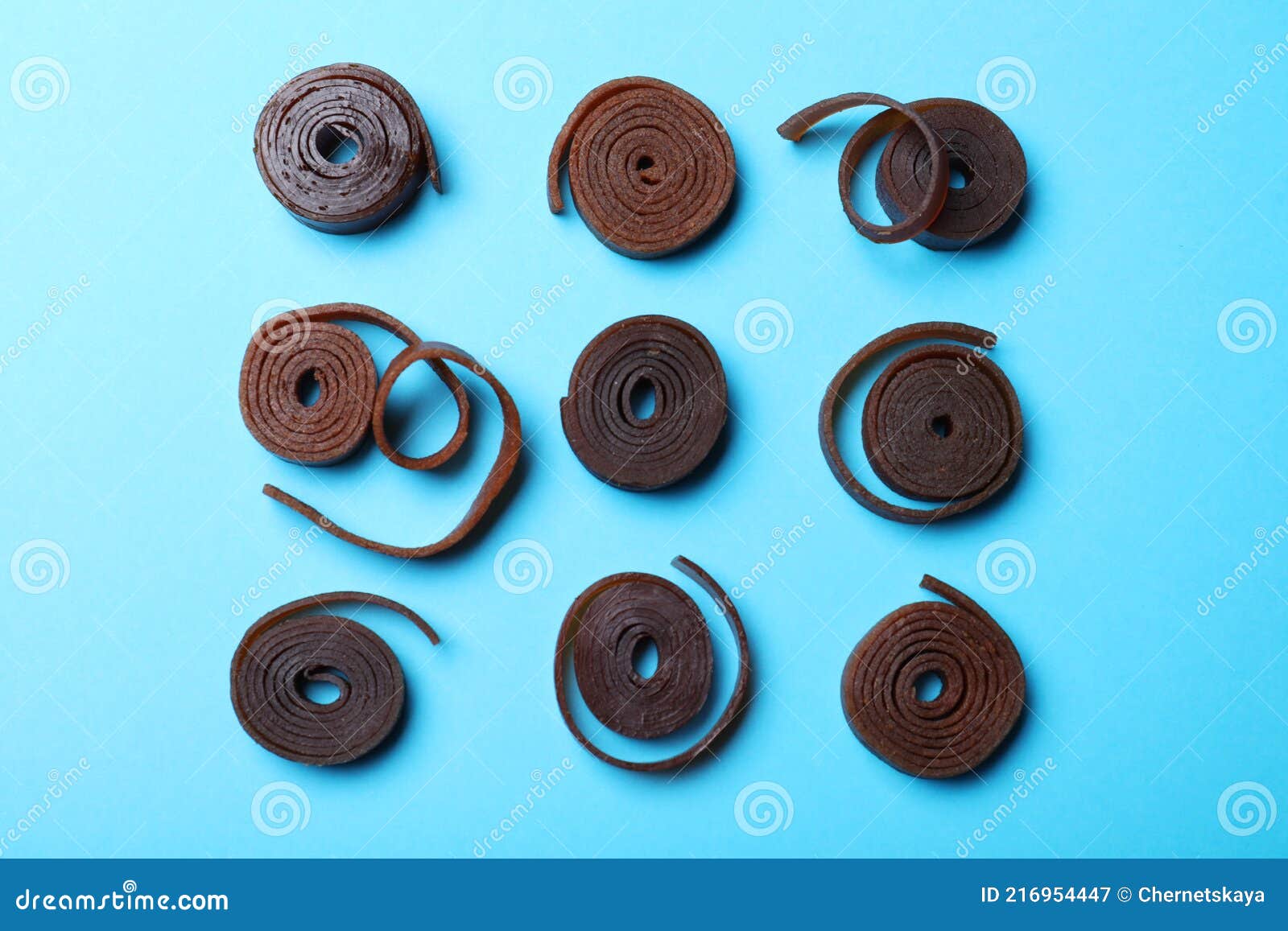 Delicious Fruit Leather Rolls on Light Blue Background, Flat Lay Stock