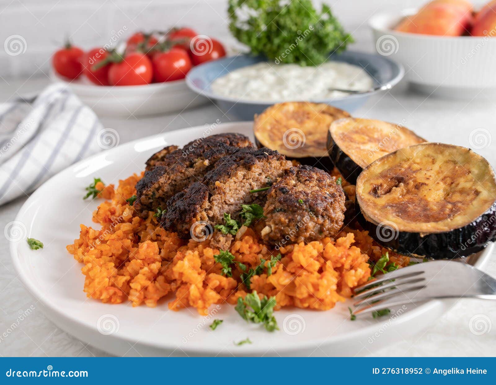 Greek Bifteki with Feta Cheese, Tomato Rice and Fried Eggplant on a ...