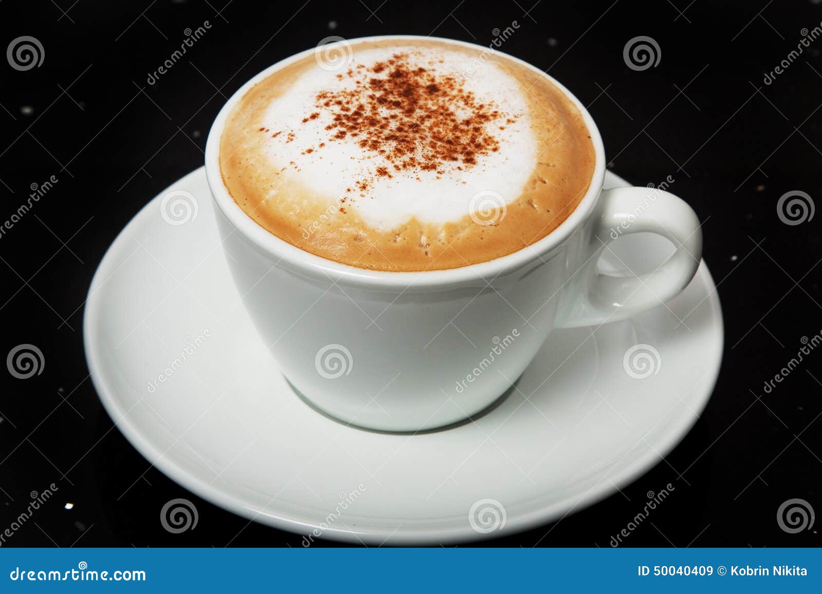 delicious hot cappuccino with cinnamon in a white cup.