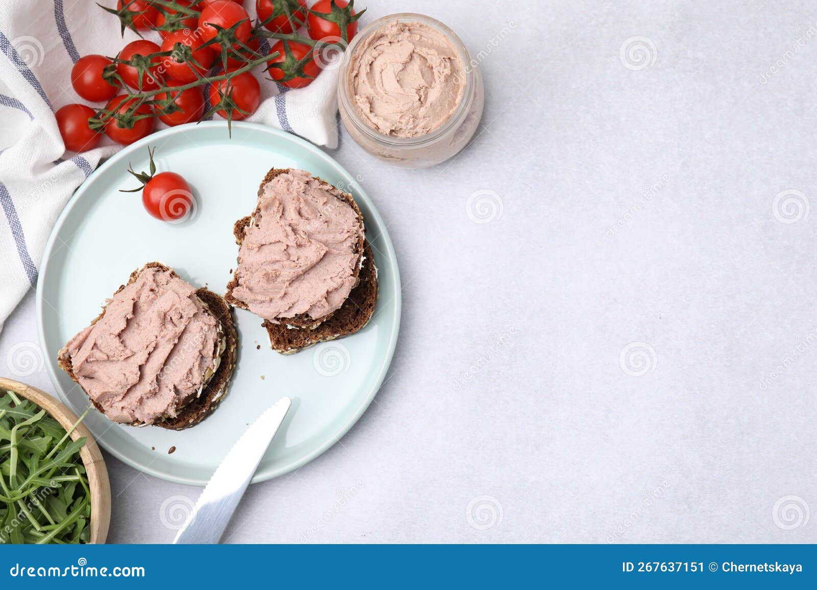 Delicious Liverwurst Sandwiches, Tomatoes and Arugula on White Table