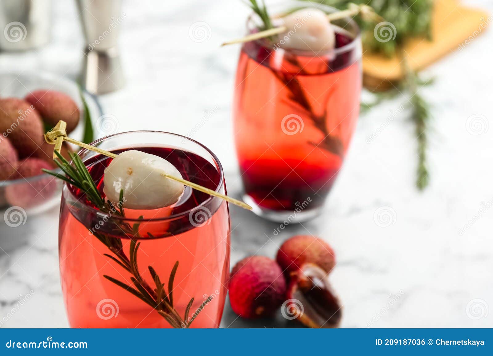 Delicious Lychee Cocktail with Rosemary on White Table, Closeup. Space