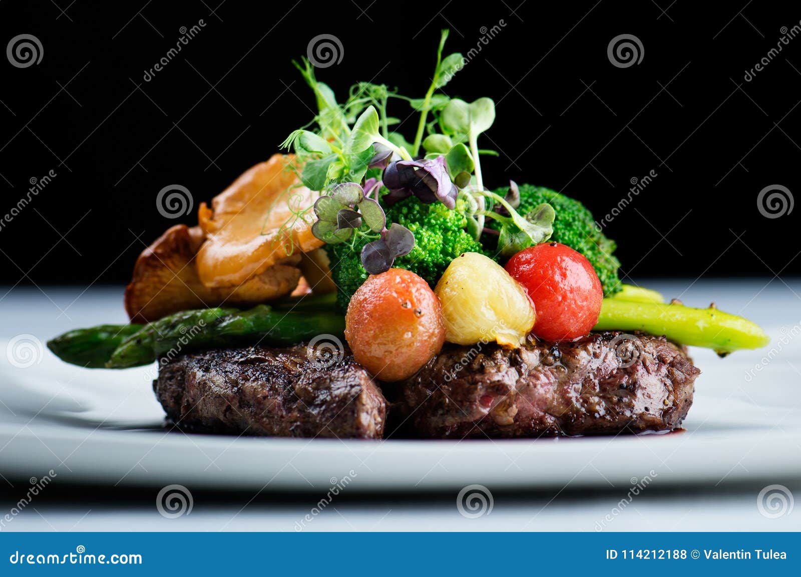 a delicious meal - ribeye steak black angus with asparagus