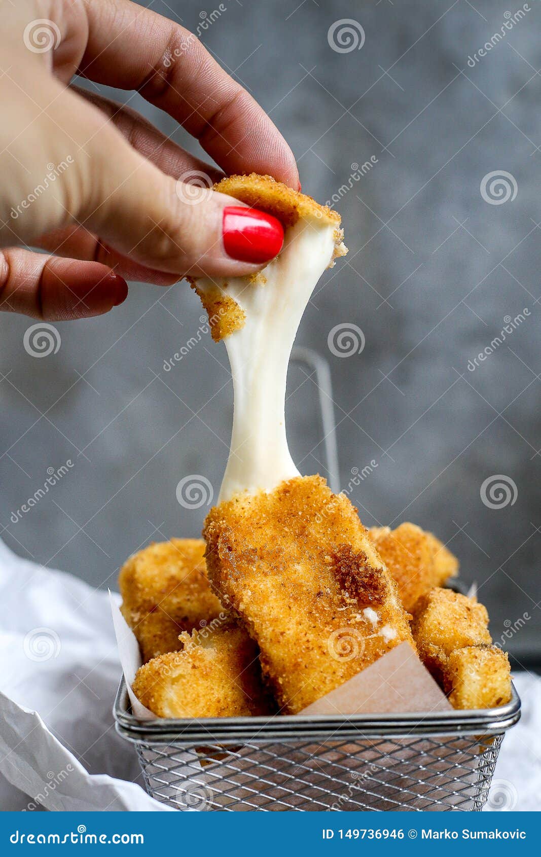 mozzarella sticks melting with woman hand