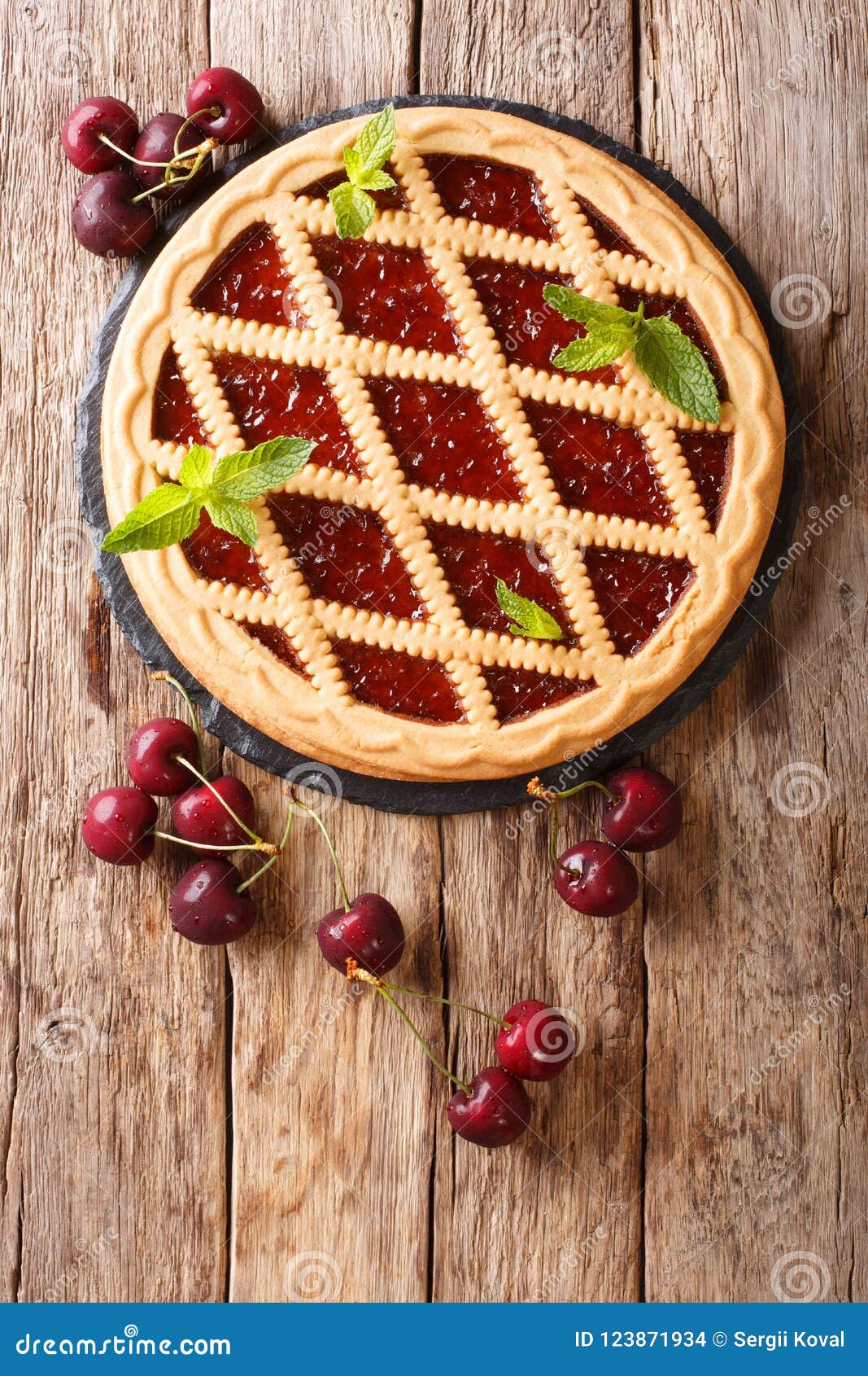 delicious open cherry pie crostata close-up on a table. vertical