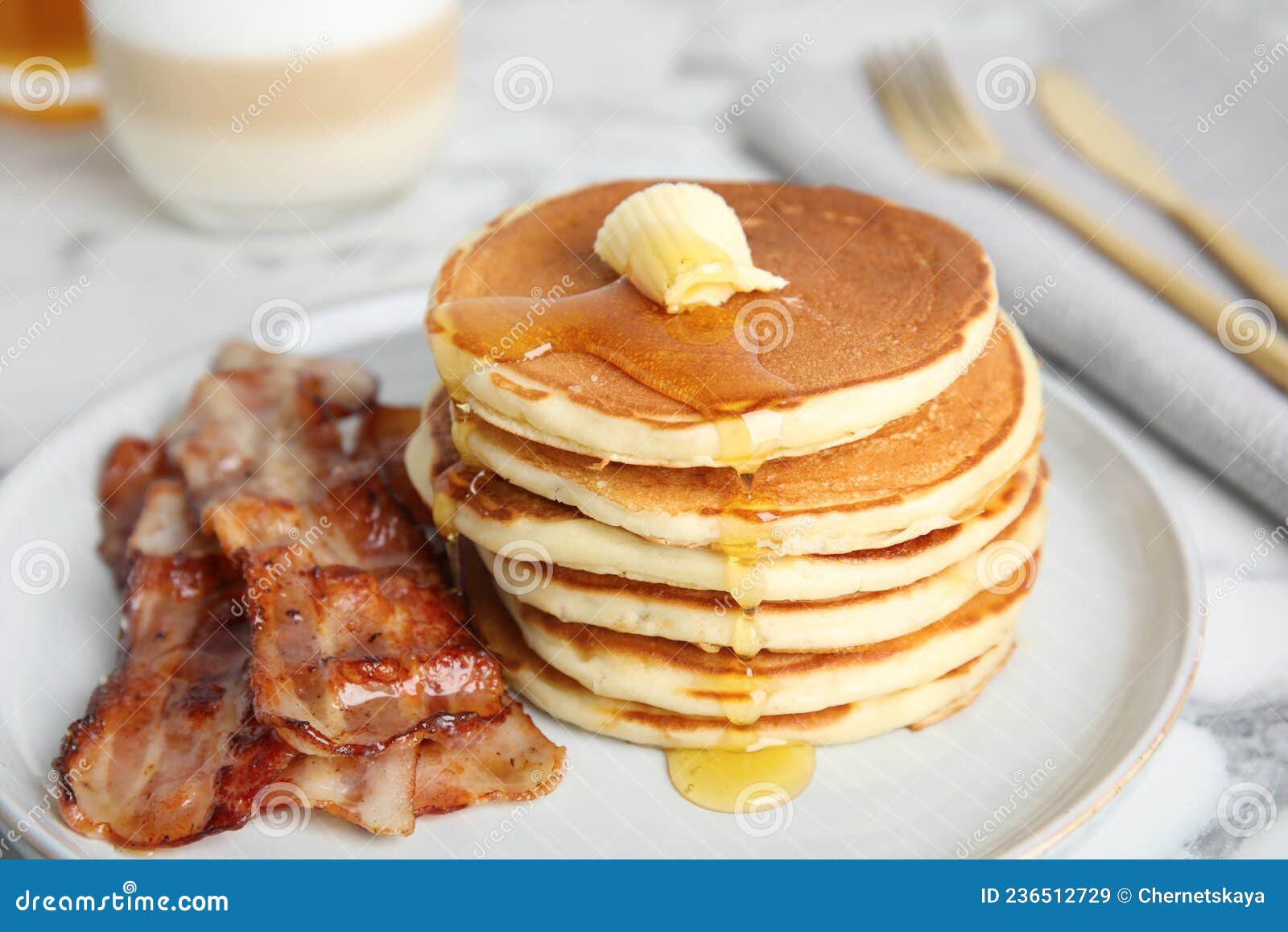 Delicious Pancakes with Maple Syrup, Butter and Fried Bacon on Table