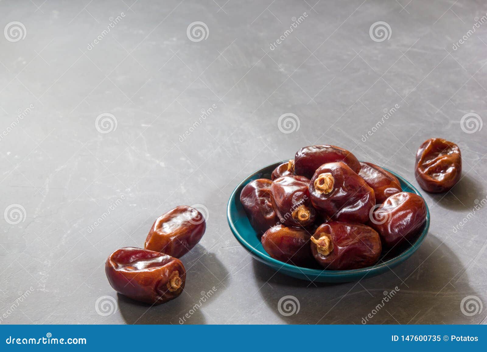 delicious pitted dates on gray table.