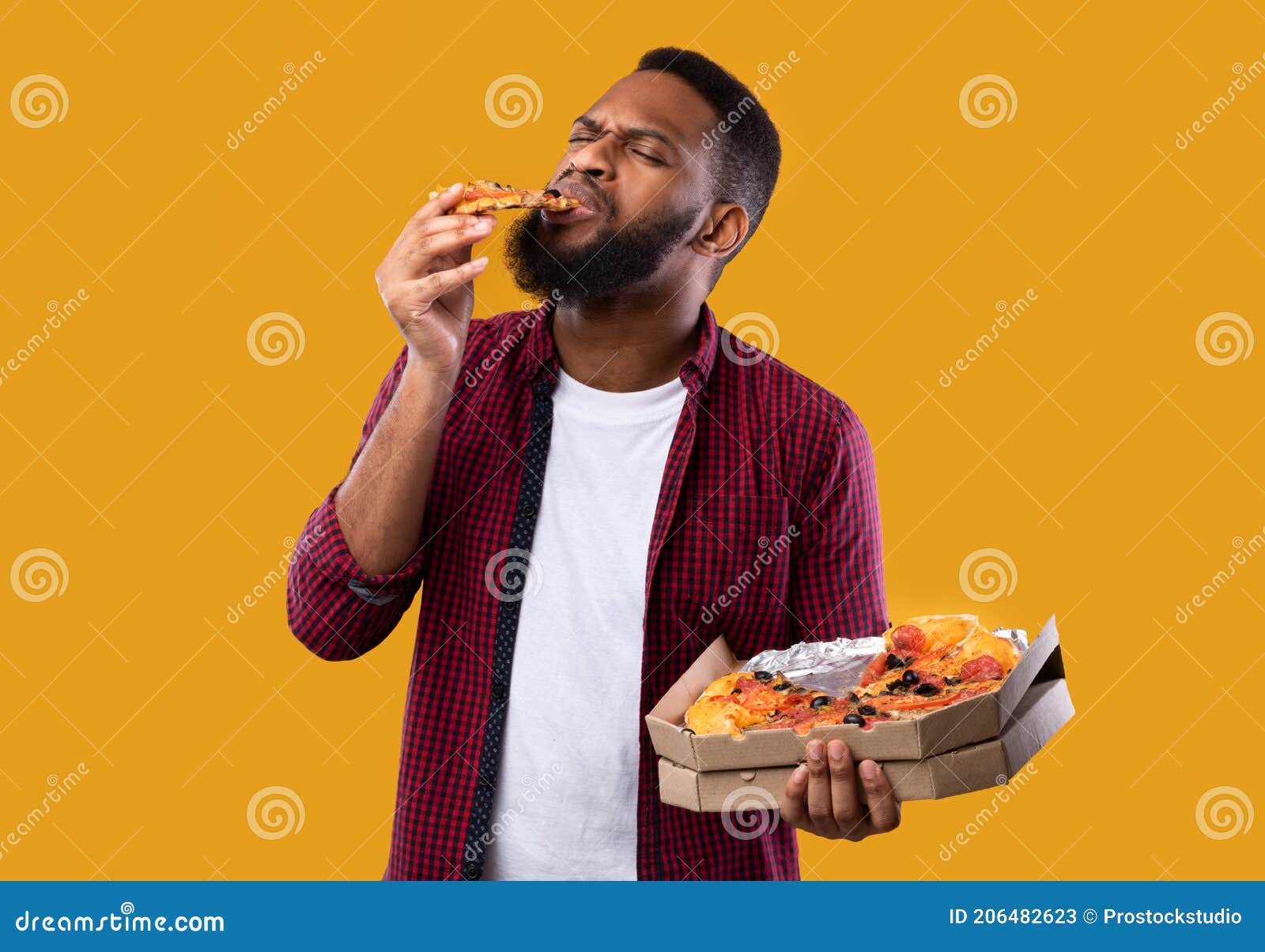 Happy african american friends eating pizza at home Stock Photo by  Prostock-studio