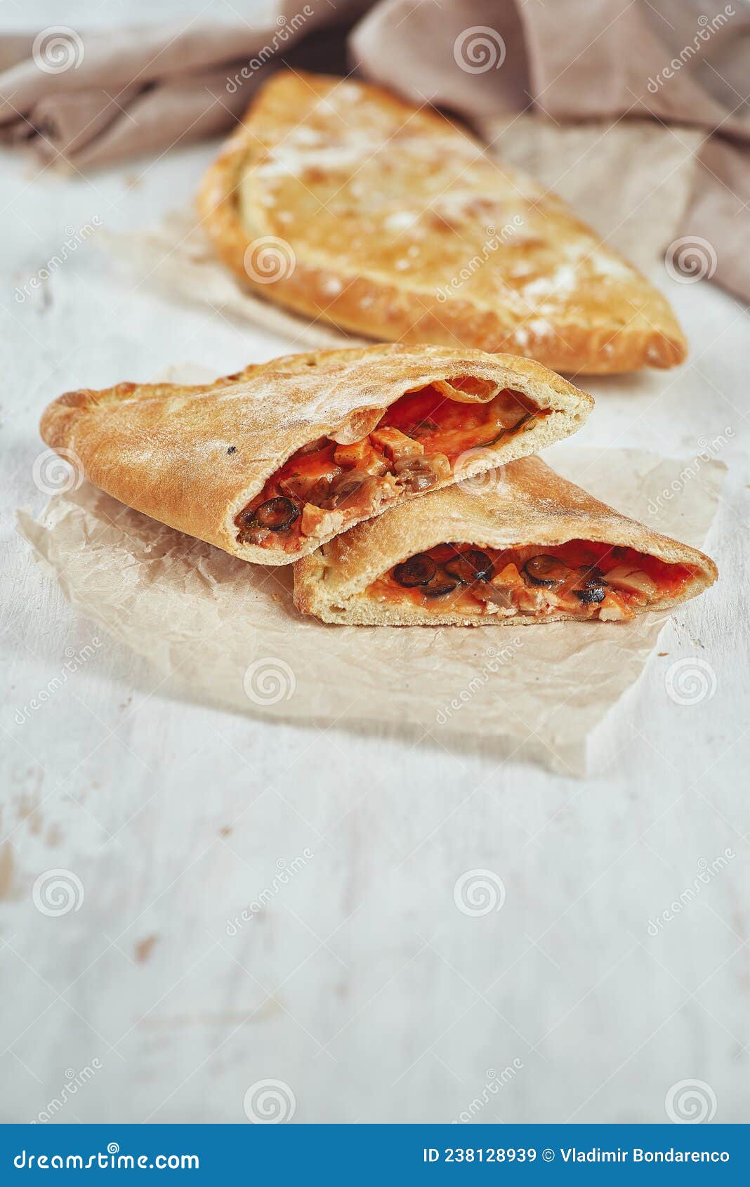 Delicious Pizza Calzone on a Table with a Light Background Stock Image