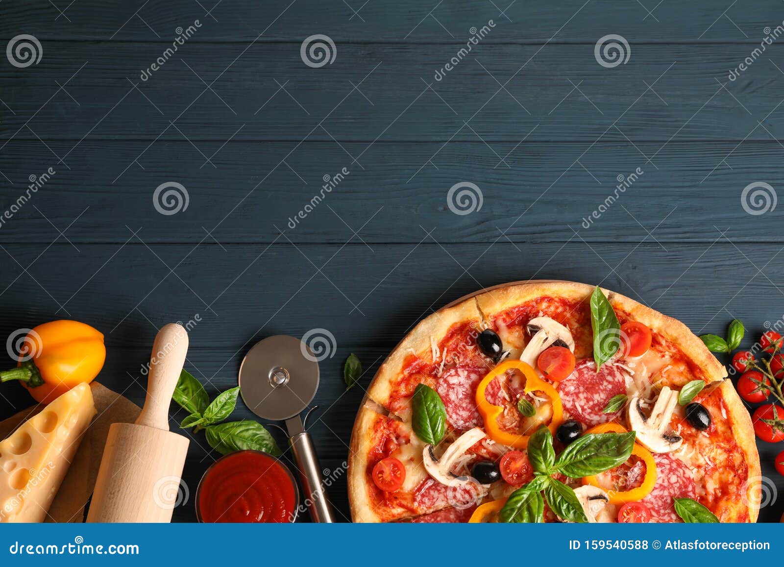 delicious pizza and ingredients on wooden background