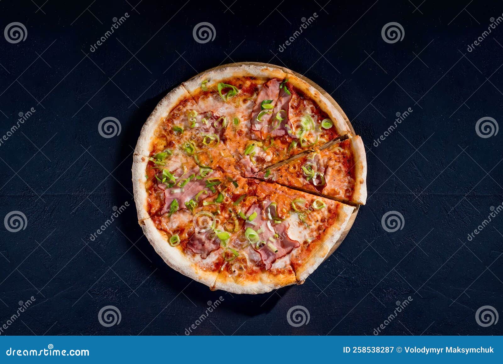 Delicious Pizza with Mozzarella Cheese, Ham, Leeks on a Tomato Base on