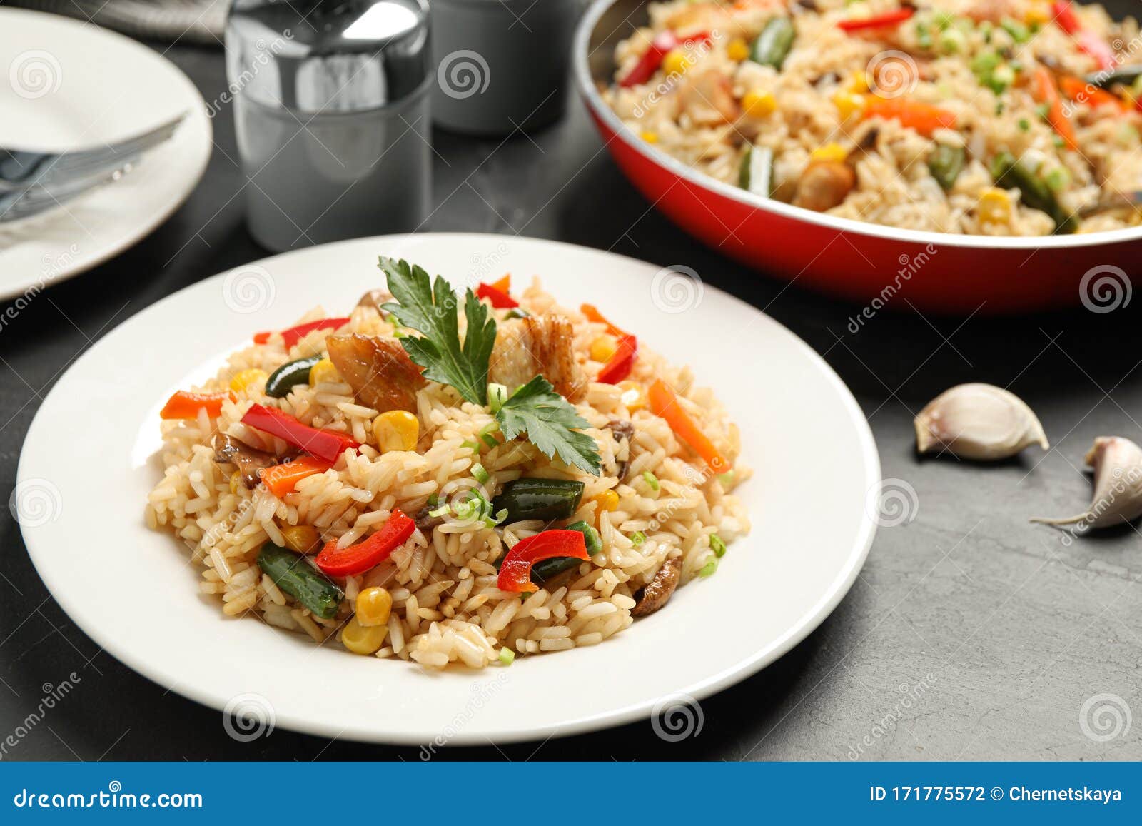 Delicious Rice Pilaf with Chicken and Vegetables on Table Stock Photo
