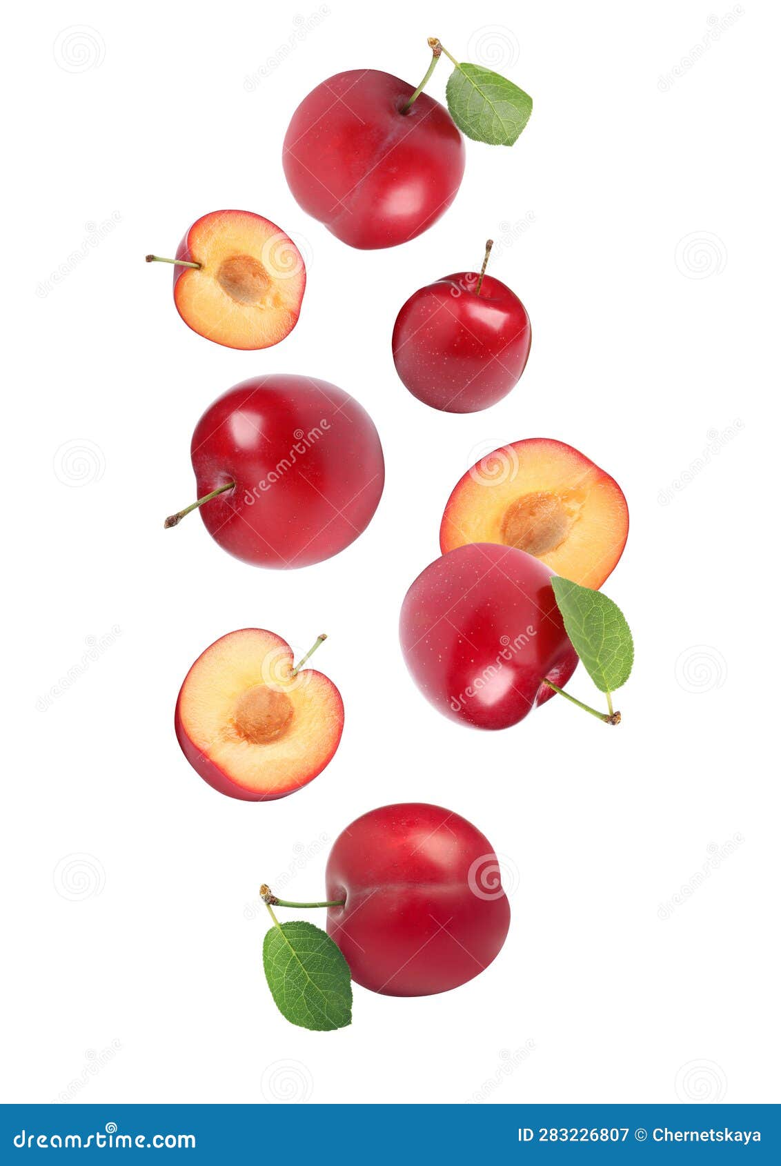 Delicious Ripe Cherry Plums with Leaves Falling Isolated on White Stock