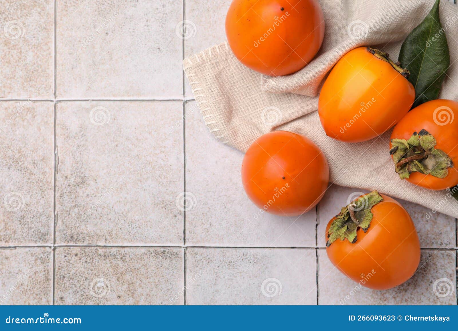 Delicious Ripe Juicy Persimmons on Tiled Surface, Flat Lay. Space for ...