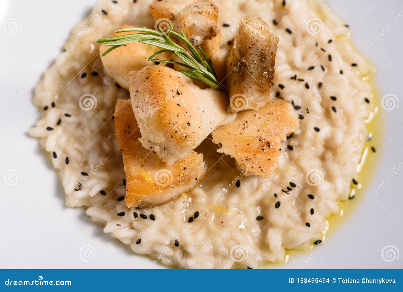 Delicious Risotto with Roasted Pieces of Chicken Fillet Stock Photo