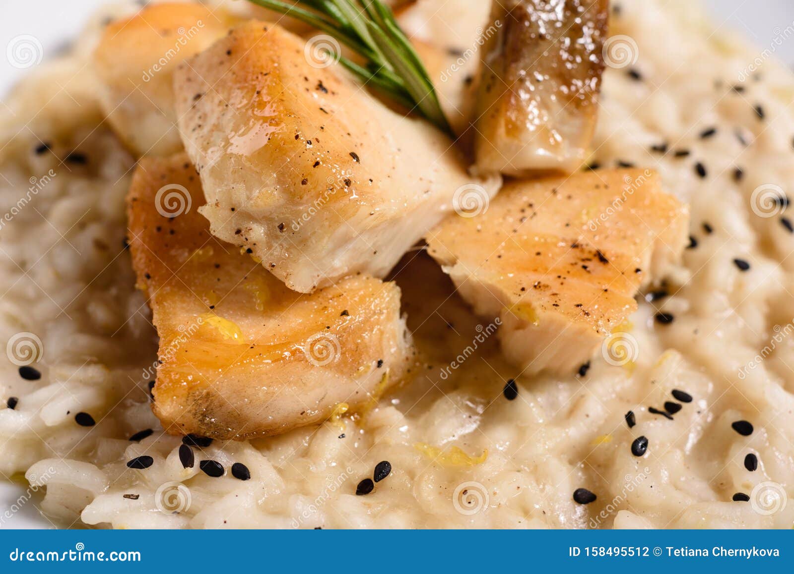 Delicious Risotto with Roasted Pieces of Chicken Fillet Stock Photo
