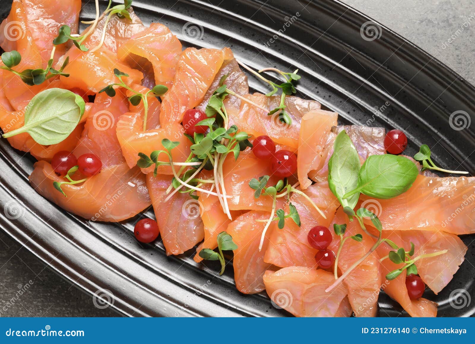 Delicious Salmon Carpaccio Served on Grey Table, Top View Stock Photo