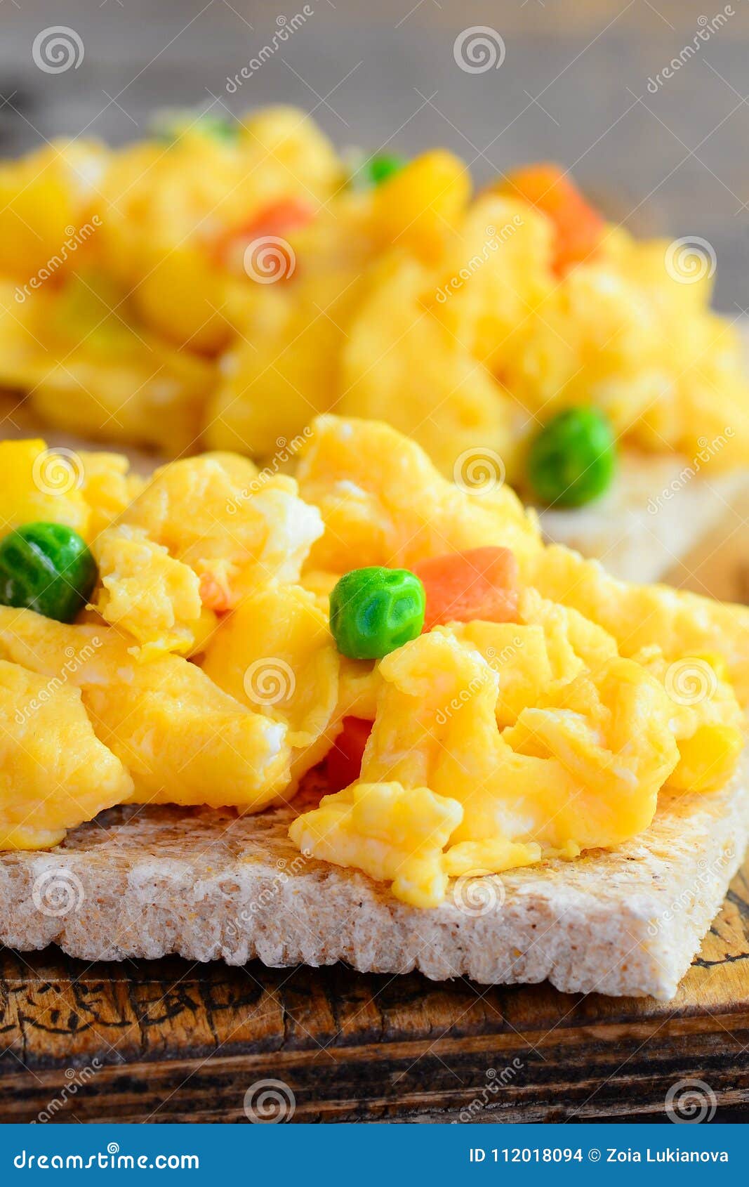 Delicious Scrambled Eggs with Vegetables on Crispy Toast. Scrambled