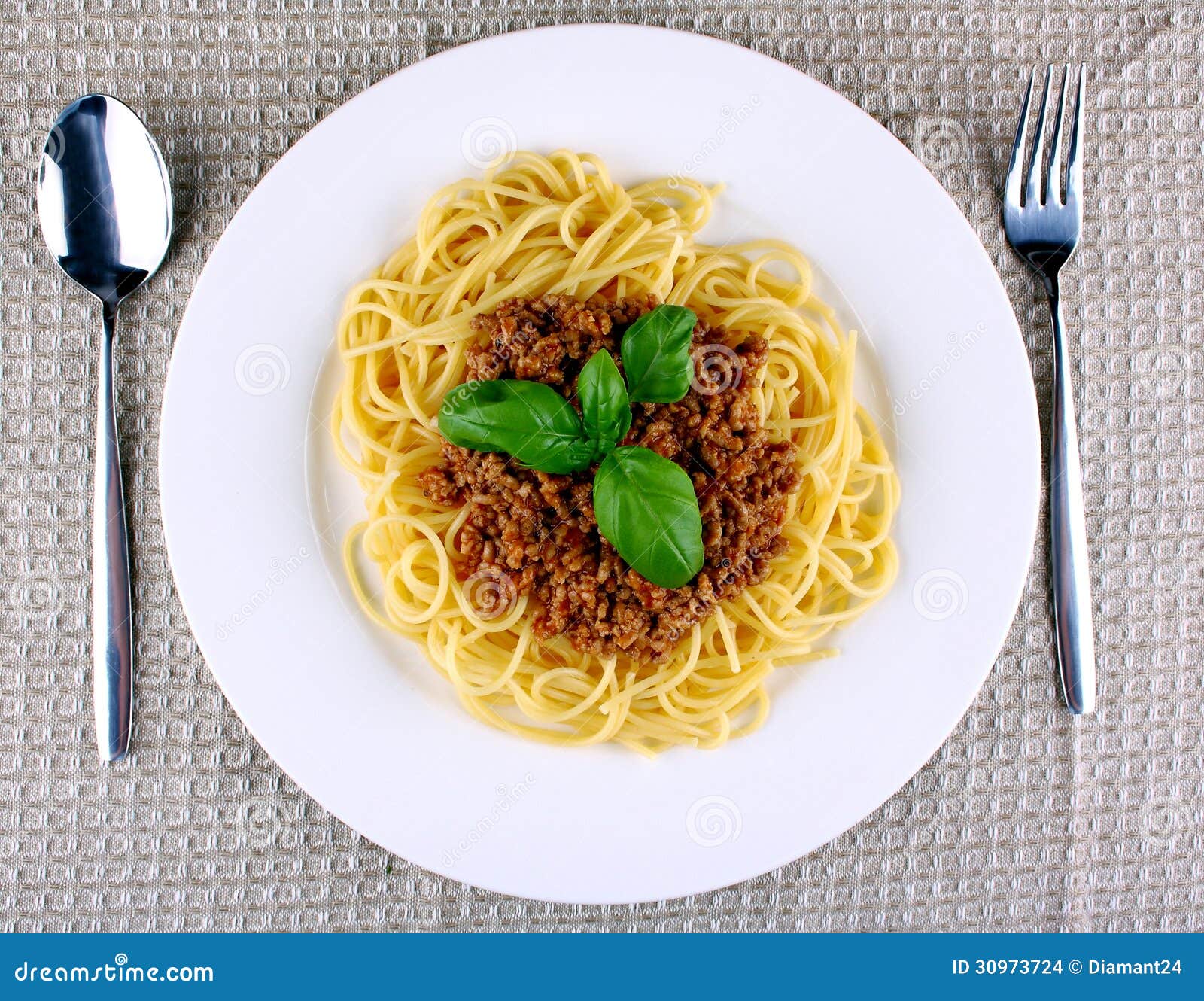 Delicious Spaghetti Bolognese with Basil on White Plate Stock Photo