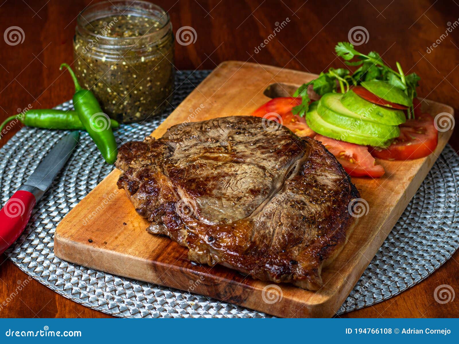 delicious steak with green sauce and avocado