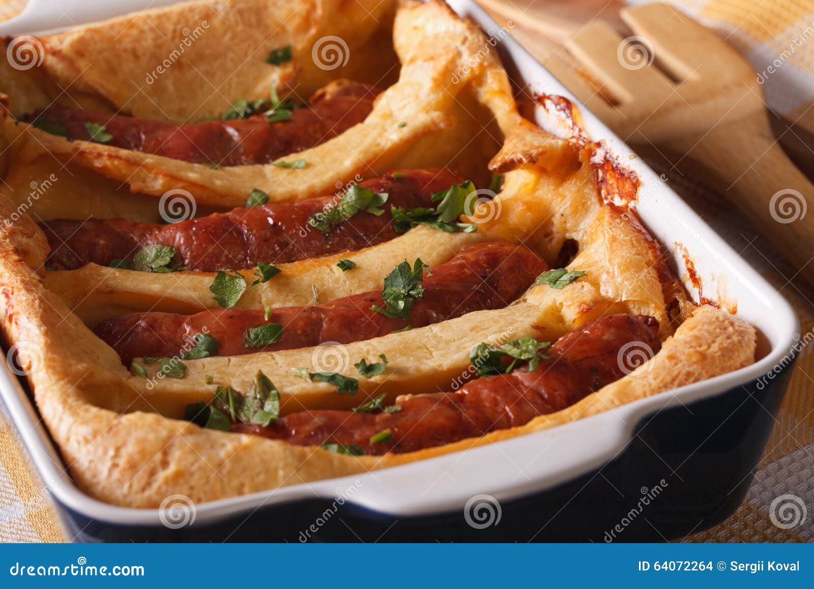 Delicious Toad in the Hole into a Baking Dish Close Up. Horizontal