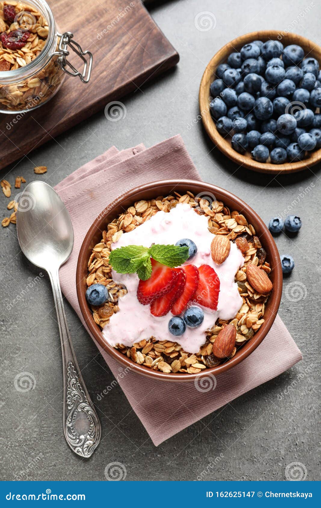 Delicious Yogurt with Granola and Berries Served on Table, Flat Lay