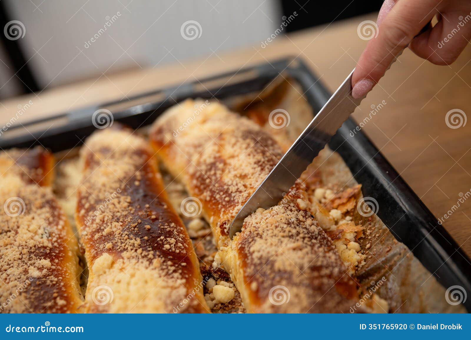 a deliciously made baked dessert with a crunchy topping being generously sliced for enjoyment