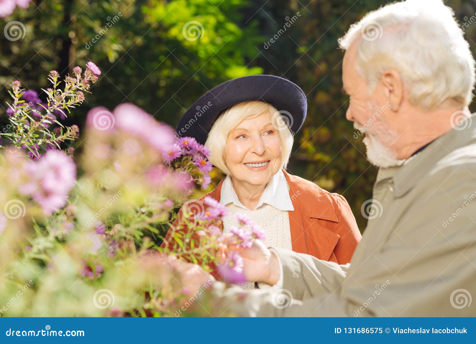 Delighted Aged Couple Standing Near the Flower Bed Stock Image - Image ...