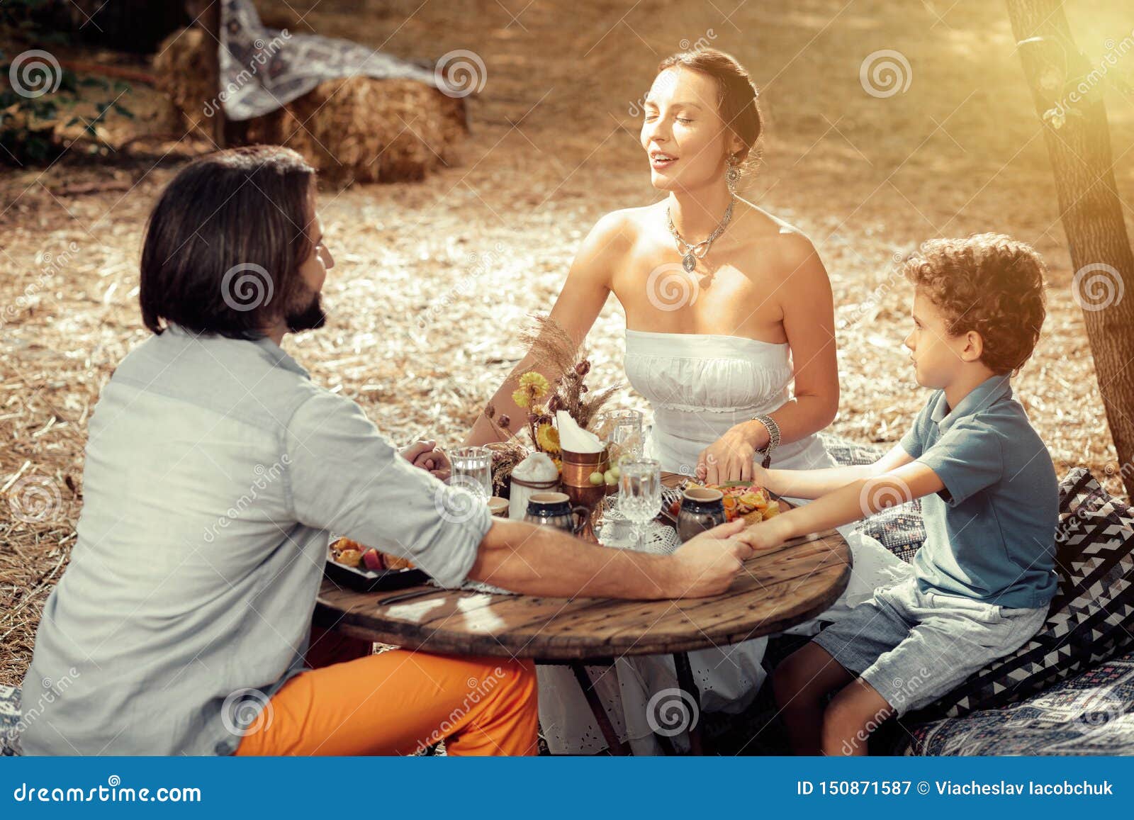 Delighted Peaceful Family Sitting Together Around the Table Stock Image
