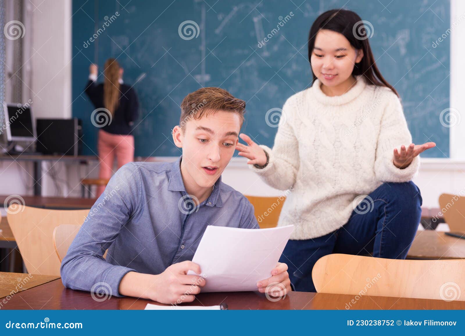 delighted teenager and chinese girl schoolmate reading notification