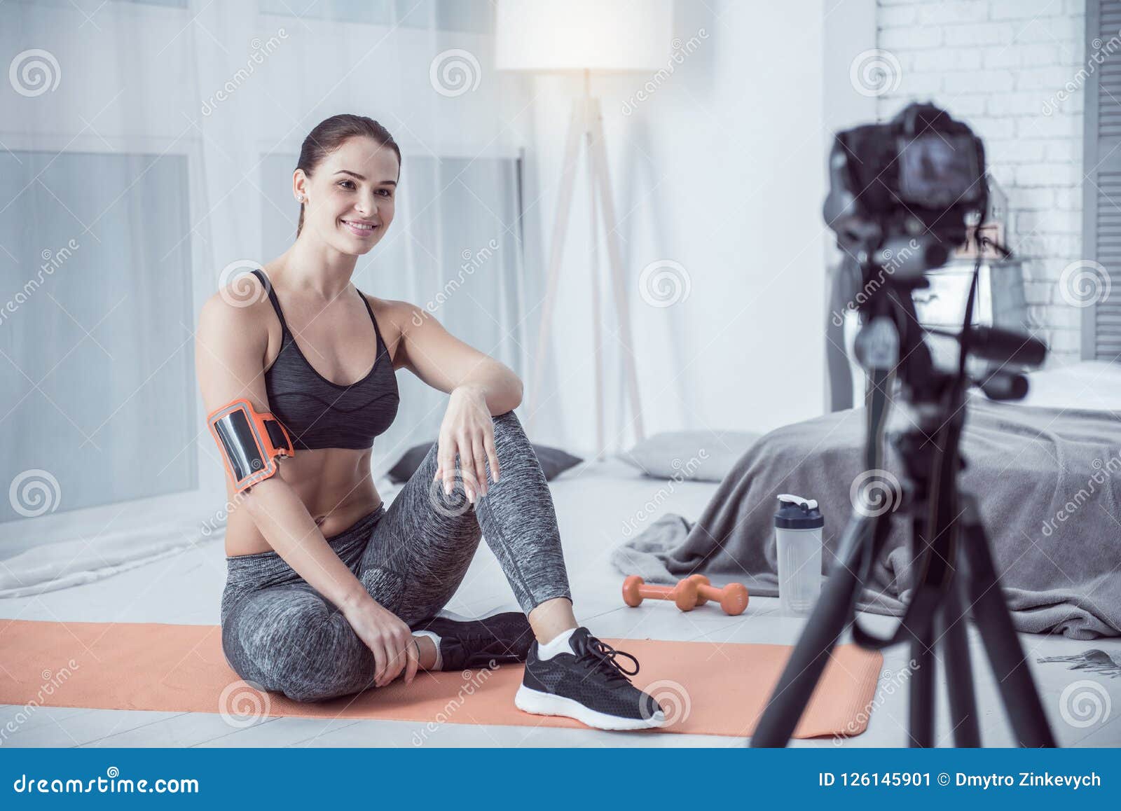 Delighted Young Woman Sitting in Front of the Camera Stock Image