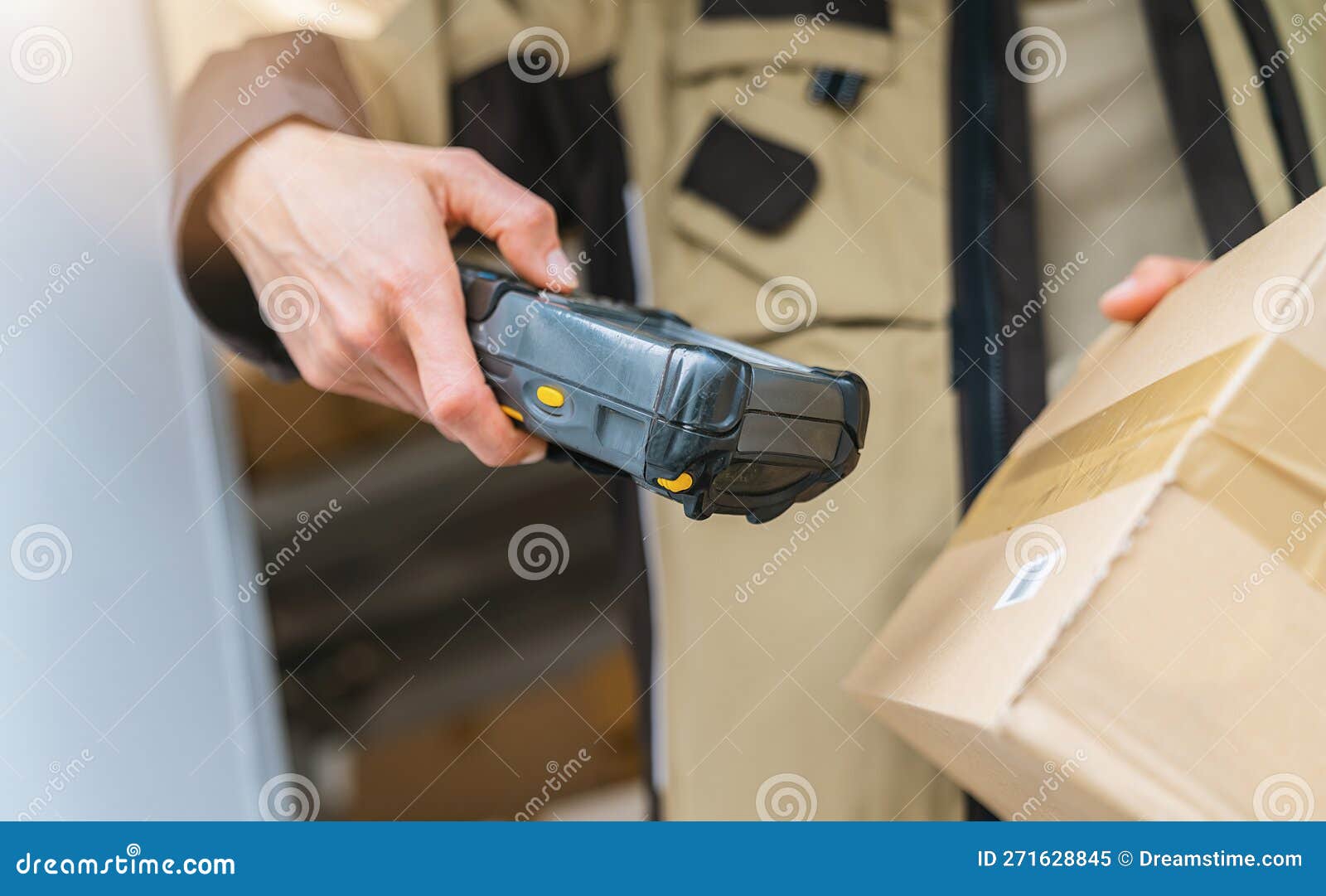 Delivery Agent Scanning Barcode with Barcode Scanner on a Parcel during