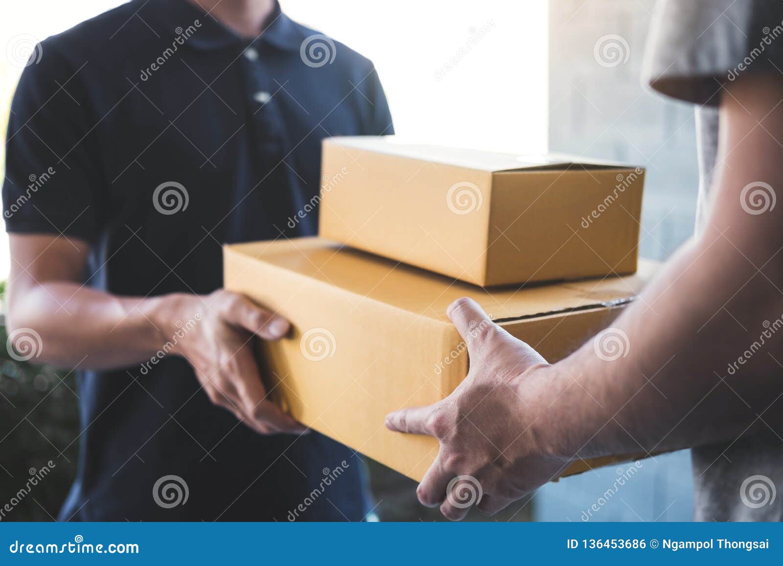delivery mail man giving parcel box to recipient, young owner accepting of cardboard boxes package from post shipment, home