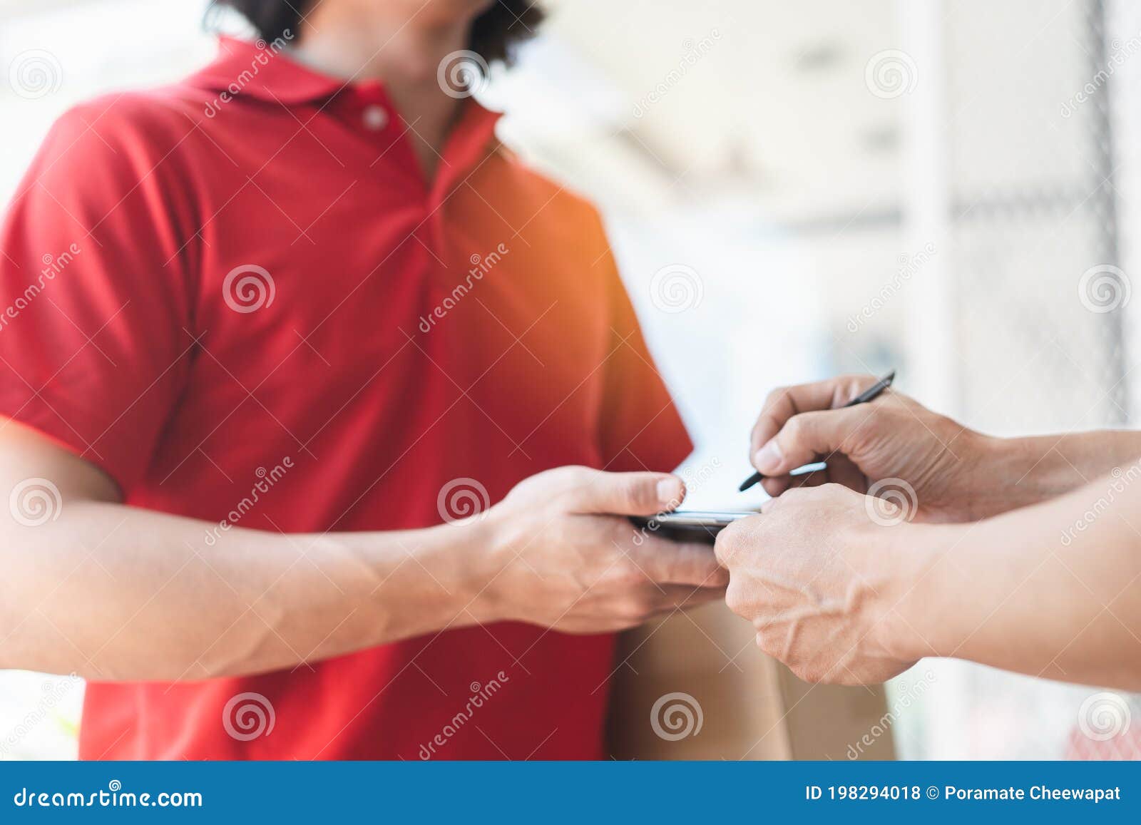 Delivery Man Sending Package To Receiver on Doorway Stock Photo Image