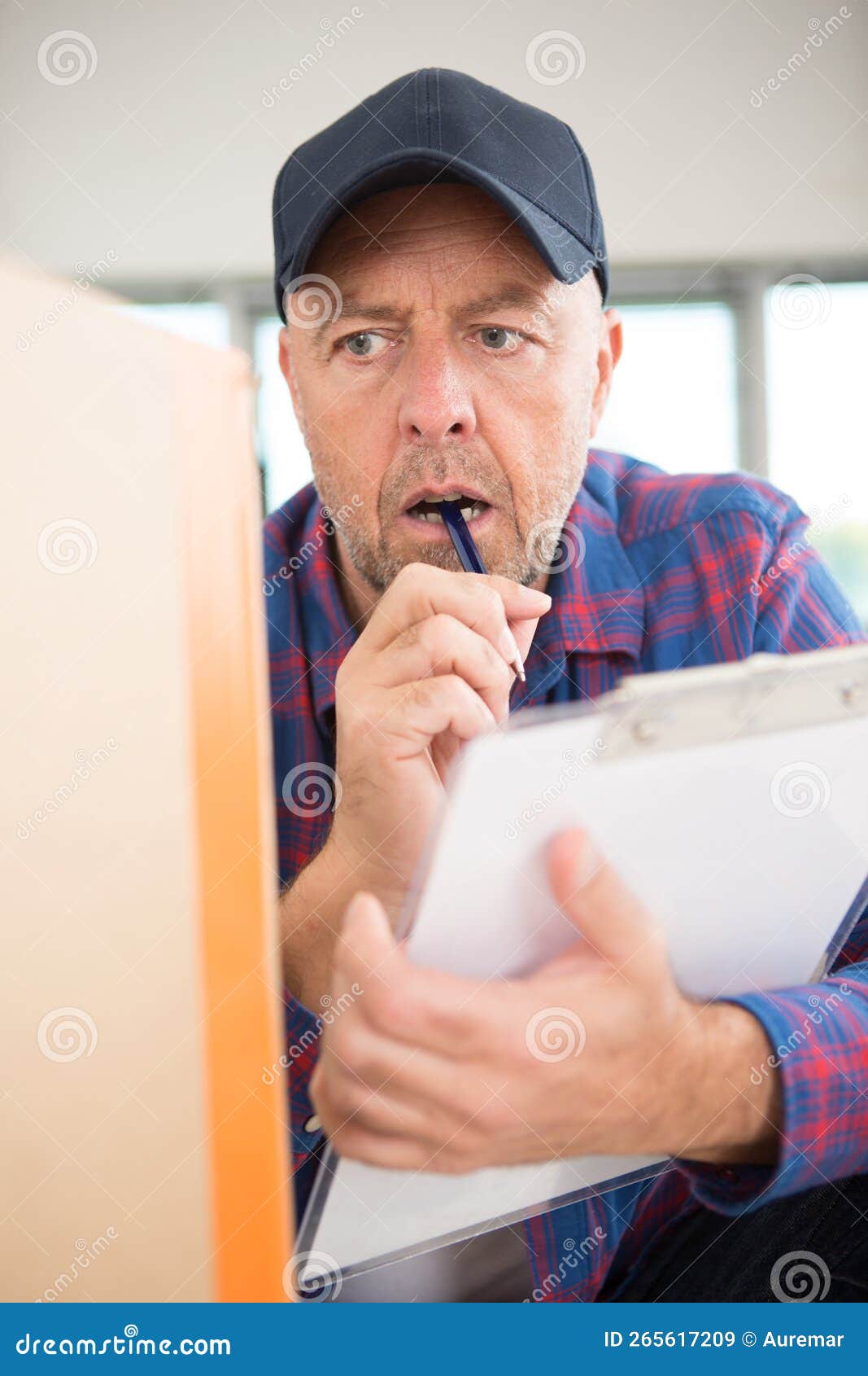 Delivery Man in Uniform Checking Box Stock Image Image of isolated