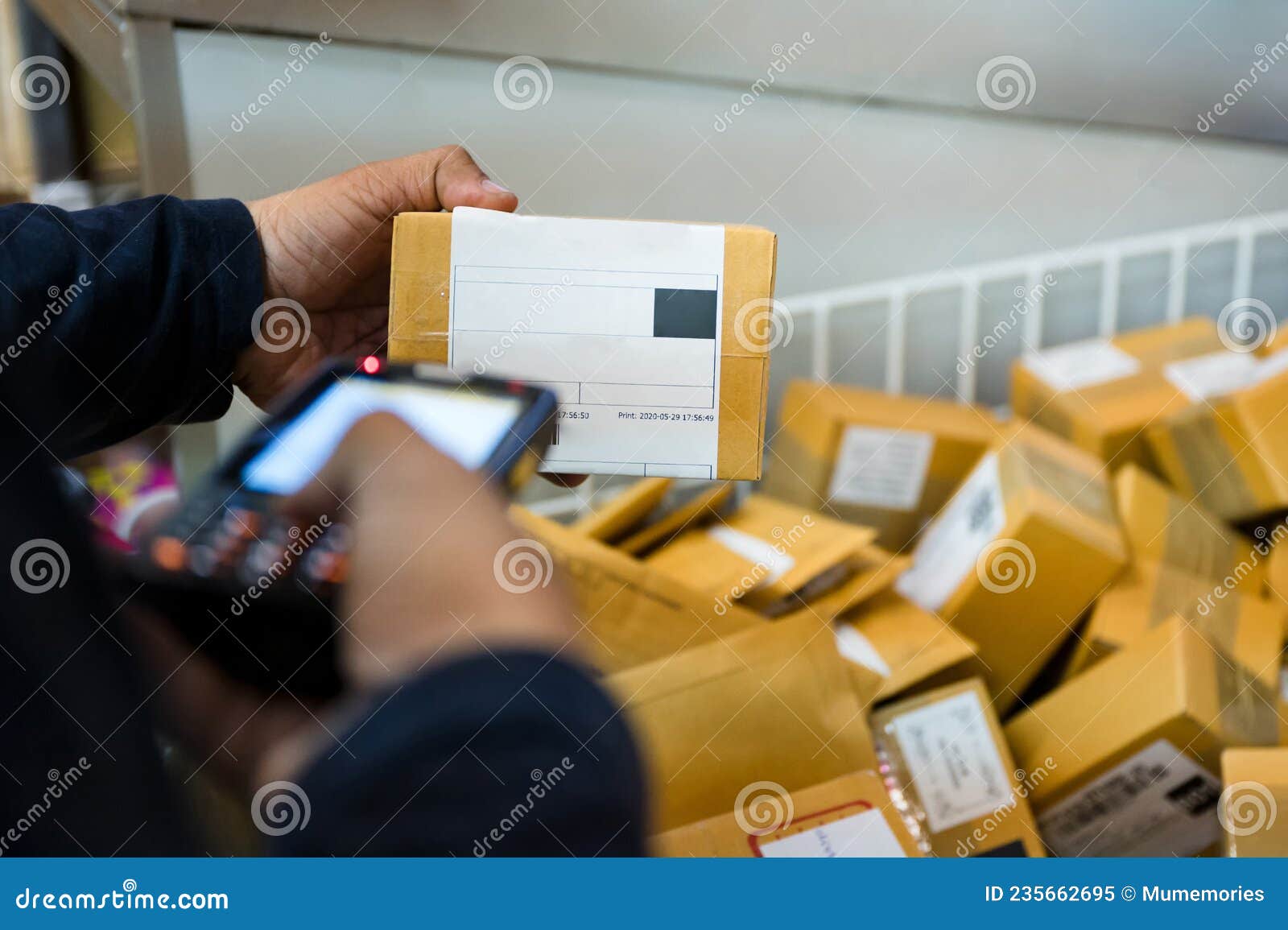 Delivery Man Using Laser Scanner Scanning Parcel Cardboard Box in