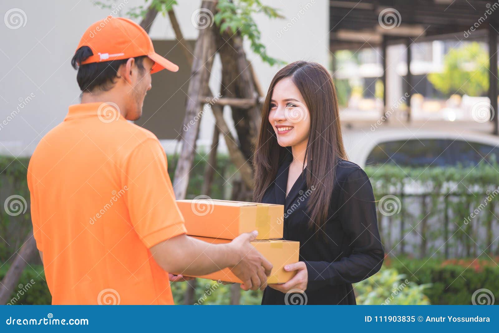 Delivery Man in Orange Bringing the Package Stock Image Image of
