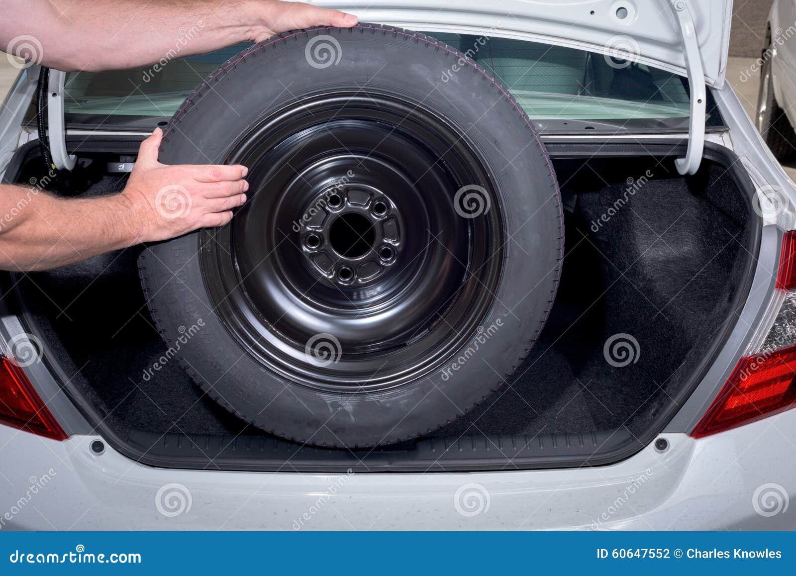 Demonstrating Spare Tire Removal from Trunk Stock Photo Image of