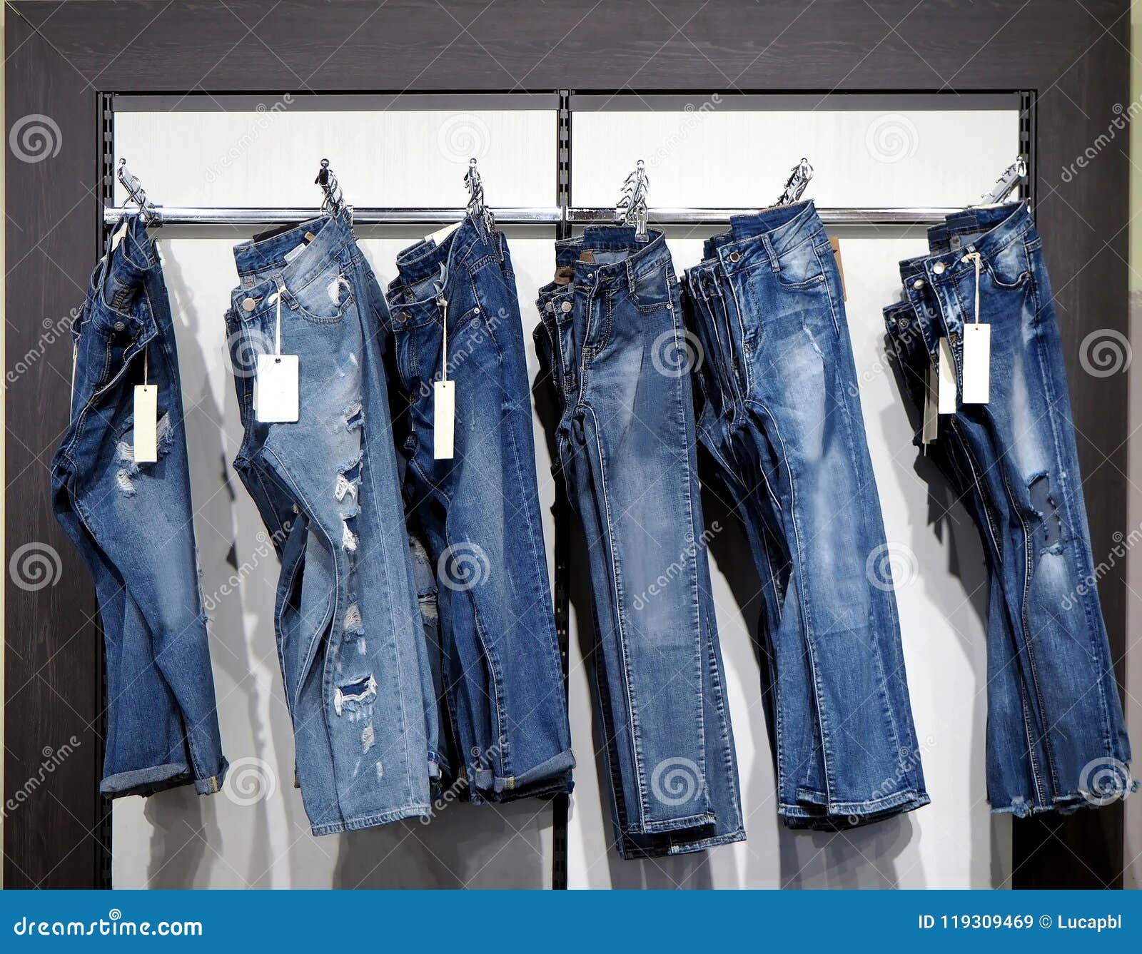 https://thumbs.dreamstime.com/z/denim-trousers-hanging-clothes-hanger-wall-store-price-tags-them-denim-trousers-hanging-clothes-hanger-119309469.jpg