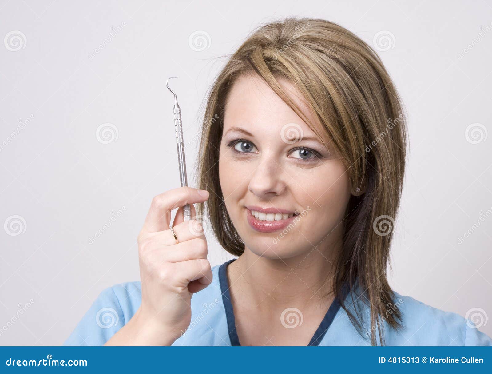 Dental Assistant Putting Dental Suction In Kid`s Mouth RoyaltyFree