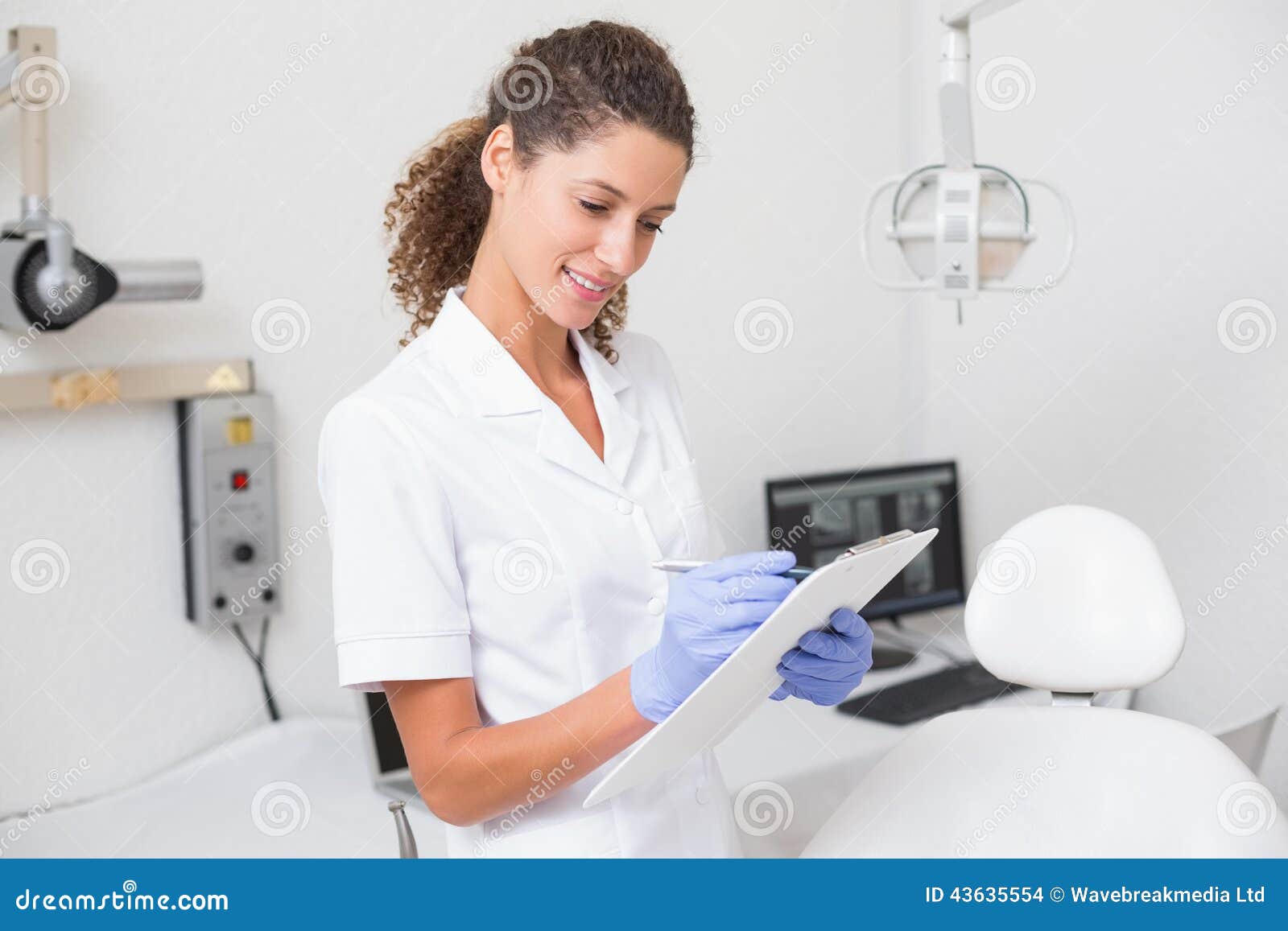 Dental Assistant Writing in Clipboard Stock Photo Image of indoors
