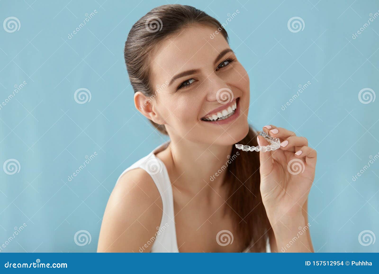 dental care. smiling woman using removable clear teeth braces